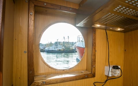 A smashed window onboard the Golden Promise at the Brixham Harbour in Devon - Credit:  SWNS.com