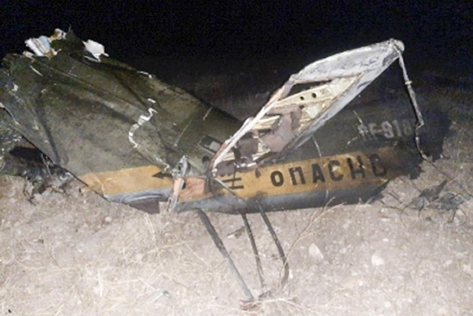 In this handout photo released by Armenian Emergency Ministry Press Office on Monday, Nov. 9, 2020, shows wreckage of a downed Russian military helicopter which was shot down in Armenia near the border with Azerbaijan. Two servicemen were killed, but the Russian Defense Ministry said the aircraft was outside the conflict area. The helicopter was downed near the border with Nakhcivan, an exclave of Azerbaijan surrounded by Armenia, Turkey and Iran. It was not clear who shot it down. (Armenian Emergency Ministry Press Office via AP)