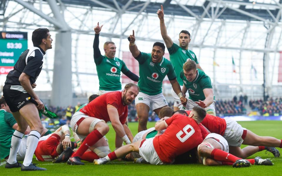 Ireland players celebrate Cian Healy's try against Wales - Sportsfile