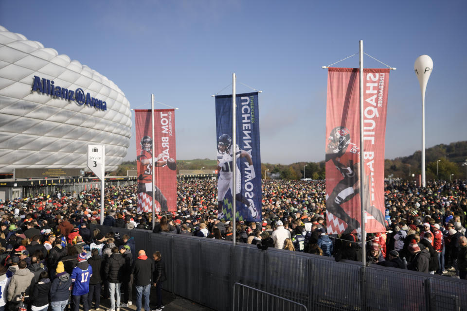 FILE - A crowd of fans arrive for an NFL football game between Tampa Bay Buccaneers and Seattle Seahawks at Allianz Arena in Munich, Germany, Sunday, Nov. 13, 2022. The NFL says there are millions of German fans who are looking for a team to support. The Chiefs go first — they’ll play the Miami Dolphins on Sunday. A week later, the Patriots face the Indianapolis Colts. Both games are at Deutsche Bank Park. (AP Photo/Markus Schreiber, File)