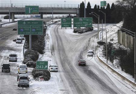 Abandoned cars litter the roadway on the Southbound Connector due to a snow storm in Atlanta, Georgia, January 29, 2014. REUTERS/Ben Gray/Atlanta Journal/Constitution/Handout via Reuters