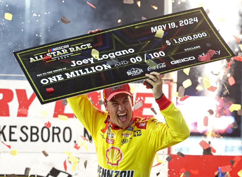 NASCAR Cup Series driver Joey Logano holds a $1 million check as he and his team celebrate winning the NASCAR All-Star race at North Wilkesboro Speedway in North Wilkesboro, NC on Sunday, May 19, 2024.