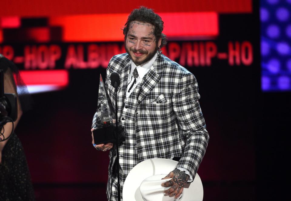 Post Malone accepts the award for favorite rap/hip-hop album for "Hollywood's Bleeding" at the American Music Awards on Nov. 24, 2019, at the Microsoft Theater in Los Angeles.