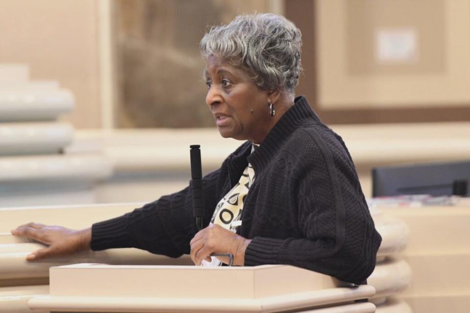 A woman leaning over a podium