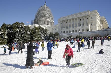 People sled on a hill at the U.S. Capitol after a major winter storm swept over Washington January 24, 2016. REUTERS/Joshua Roberts