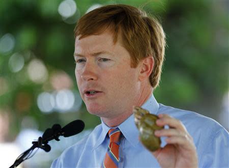 Florida Commissioner of Agriculture Adam Putnam holds a shell as he speaks at a news conference about successes in attempts to eradicate the Giant African Land Snail in Miami, Florida August 29, 2013. REUTERS/Joe Skipper