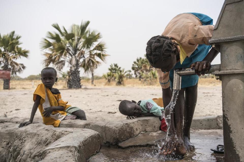 In this photo taken Sunday, March 12, 2017, a girl Abuk washes her legs at a water point four kilometers from her home in Aweil, in South Sudan. As World Water Day approaches on March 22, more than 5 million people in South Sudan, do not have access to safe, clean water, compounding the problems of famine and civil war, according to the UNICEF. (Mackenzie Knowles-Coursin/UNICEF via AP)