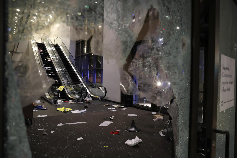 Glass is shattered in the Nordstrom store after a riot occurred in the Gold Coast area of the city early in the morning of Monday, Aug. 10, 2020 in Chicago. Hundreds of people smashed windows, stole from stores and clashed with police in Chicago's Magnificent Mile shopping district and other parts of the city's downtown. (Jose M. Osorio /Chicago Tribune via AP)