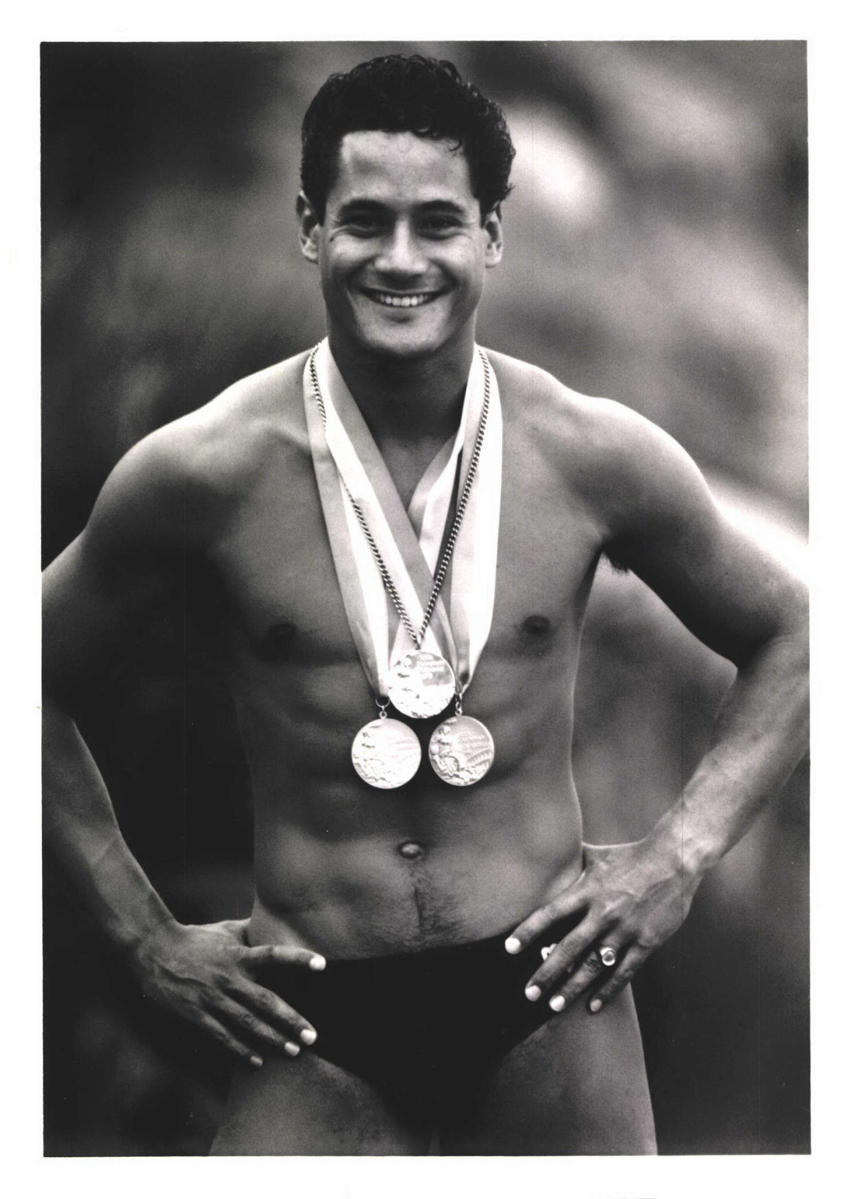 Olympian Greg Louganis posing with his two gold medals and silver medal. (Greg Louganis)