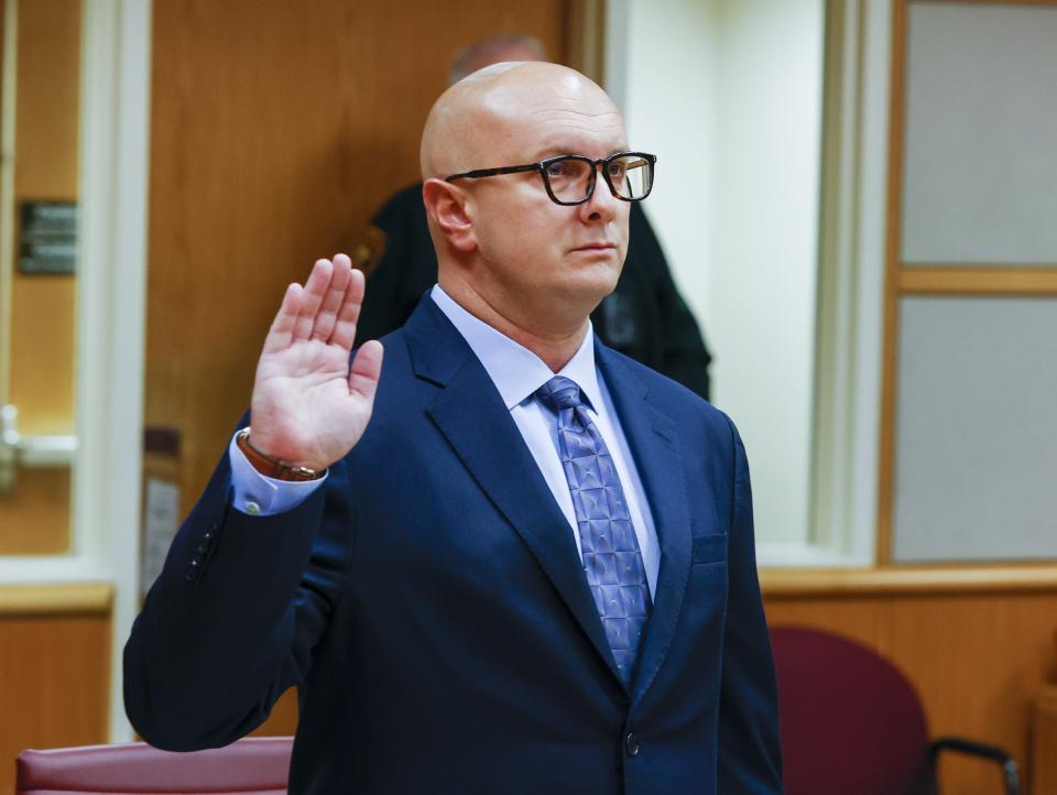 William Braddock raises his hand to take an oath during a hearing Tuesday, June 22, 2021, in Clearwater, Fla. Anna Paulina Luna, who plans to run for Florida's District 13 seat after losing a race for the slot in 2020 to Democratic U.S. Rep. Charlie Crist, contends in court documents that GOP challenger William Braddock is stalking her and wants her dead. Luna has filed a petition for a permanent restraining order. Braddock denies the claims and wants to see any evidence against him. (Chris Urso/Tampa Bay Times via AP)