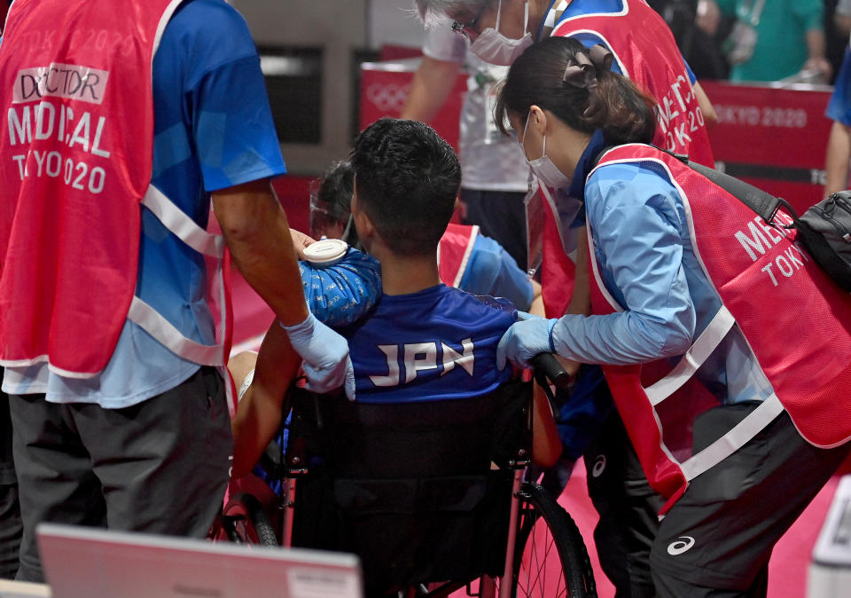 TOKYO, JAPAN - AUGUST 03: Ryomei Tanaka of Team Japan gets medical treatment during the Men's Fly (48-52kg) quarter final on day eleven of the Tokyo 2020 Olympic Games at Kokugikan Arena on August 03, 2021 in Tokyo, Japan. (Photo by Luis Robayo - Pool/Getty Images)