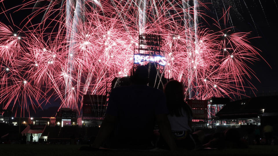 FILE - In this July 3, 2019, file photo, fireworks explode over Coors Field after a baseball game to mark the Fourth of July holiday in Denver. With fewer professional celebrations on July 4, 2020 due to the coronavirus, many Americans are bound to shoot off fireworks in backyards and at block parties. And they already are: Sales have been booming. (AP Photo/David Zalubowski, File)