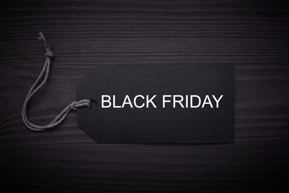 Black Friday text on a black tag on black paper background