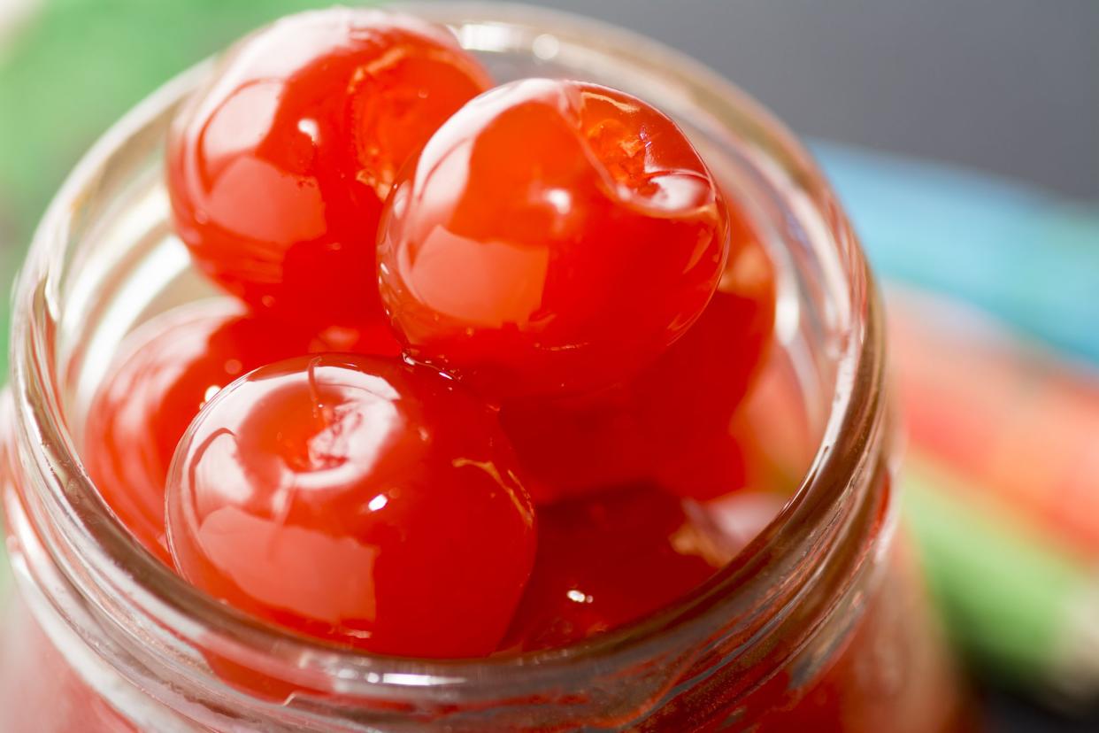 Colourful close up of Maraschino cherries in a jar using a selective view, with room for copy space