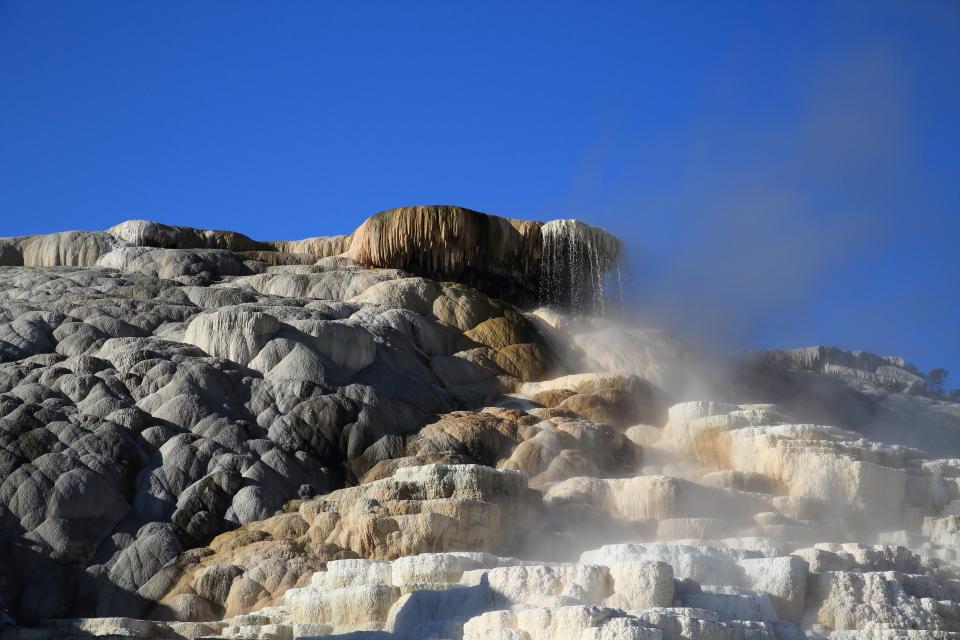 Travertine often forms at the mouth of hot springs, as seen here.