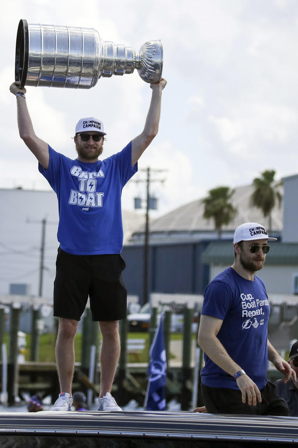 Tampa Bay Lightning center Steven Stamkos holds up the Stanley Cup as teammate defenseman Victor Hedman, right, looks on as they celebrate the teams Stanley Cup victory with a boat parade Monday, July 12, 2021 in Tampa, Fla. (Dirk Shadd/Tampa Bay Times via AP)