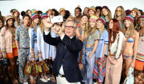 <p>Models just magically get made up, take a few fun selfies and then strut onto the catwalk. <i>[Photo by Kevin Mazur/Getty Images for Tommy Hilfiger]</i></p>