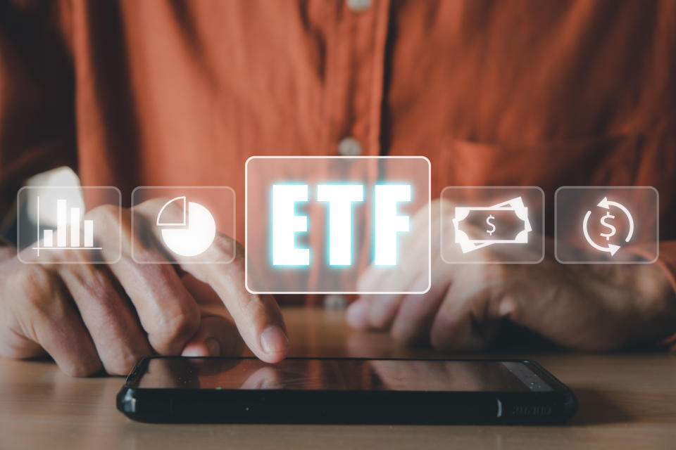 ETF Exchange traded fund stock market trading investment financial concept, Man using smart phone with icons of ETF on vr screen.