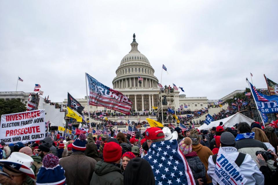 A mob of Donald Trump’s supporters storm the US Capitol on 6 January 2021 (AP)