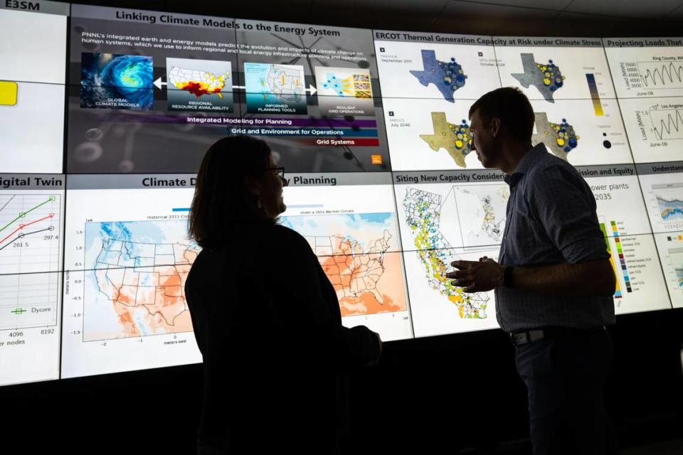 Scientists at PNNL, including Nathalie Voisin, left, and Casey Burleyson, use advanced climate models that represent interactions between energy, water, land, climate and socioeconomic systems as they study how climate change and extreme weather impact the electric grid.