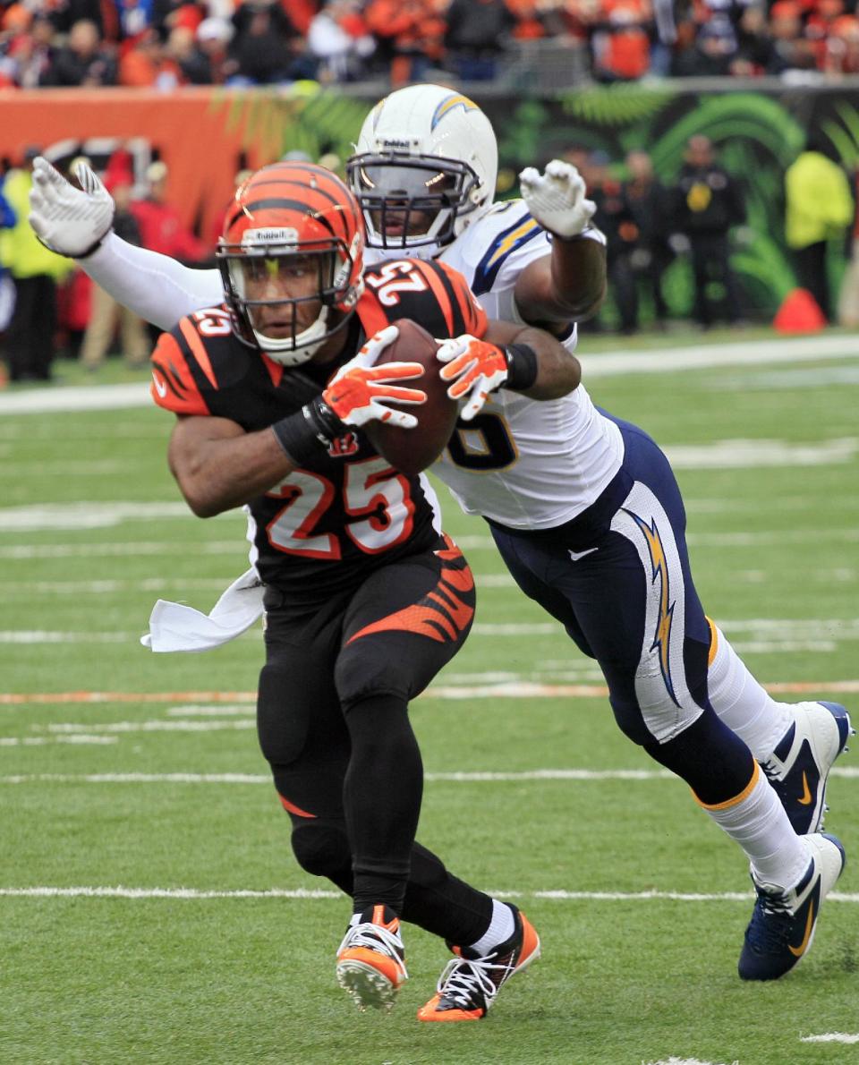 San Diego Chargers linebacker Donald Butler, right, chases down Cincinnati Bengals running back Giovani Bernard in the first half of an NFL wild-card playoff football game on Sunday, Jan. 5, 2014, in Cincinnati. Bernard fumbled on the play and the Chargers recovered the ball. (AP Photo/Tom Uhlman)