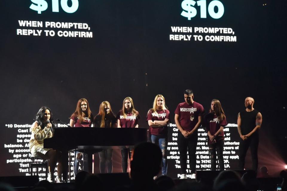 Demi Lovato onstage with Marjory Stoneman Douglas High School students