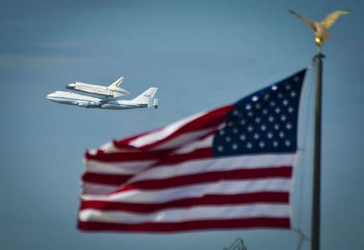 US space shuttle Discovery sitting atop NASA's 747 shuttle carrier aircraft flies over the National Mall in Washington