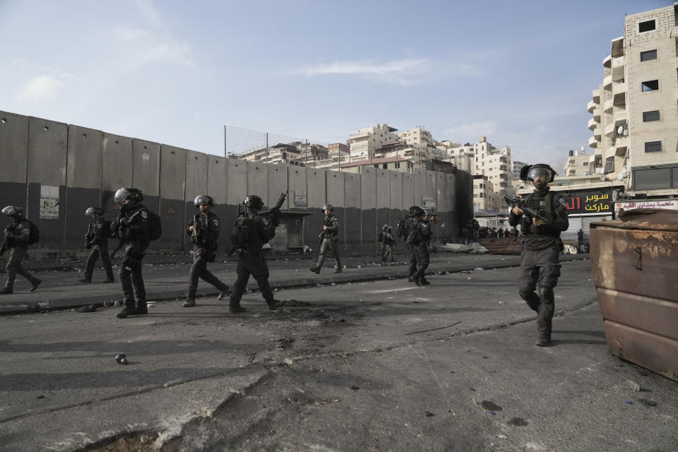 FILE - Israeli police clashes with Palestinians in Shuafat refugee camp in east Jerusalem, Wednesday, Oct.12. 2022. The clashes began Israeli security forces set up checkpoints that choked off the only exit and entry points of the camp during a manhunt following the death of a soldier, bringing life to a standstill for its estimated 60,000 residents. (AP Photo/Mahmoud Illean, File)