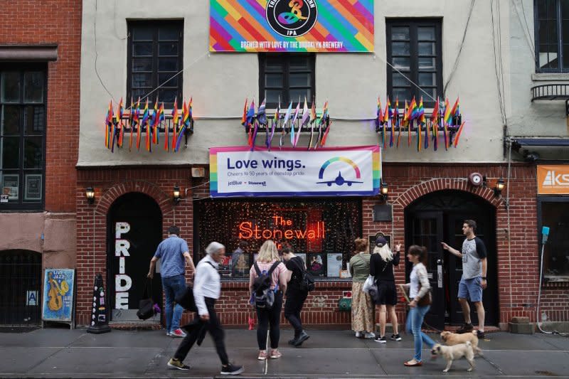 People stop to take pictures of the Stonewall Inn during LGBT Pride Month on June 19. On June 28, 1969, the clientele of the Stonewall Inn rioted after it was raided by police. The event is considered the start of the gay liberation movement. Photo by John Angelillo/UPI