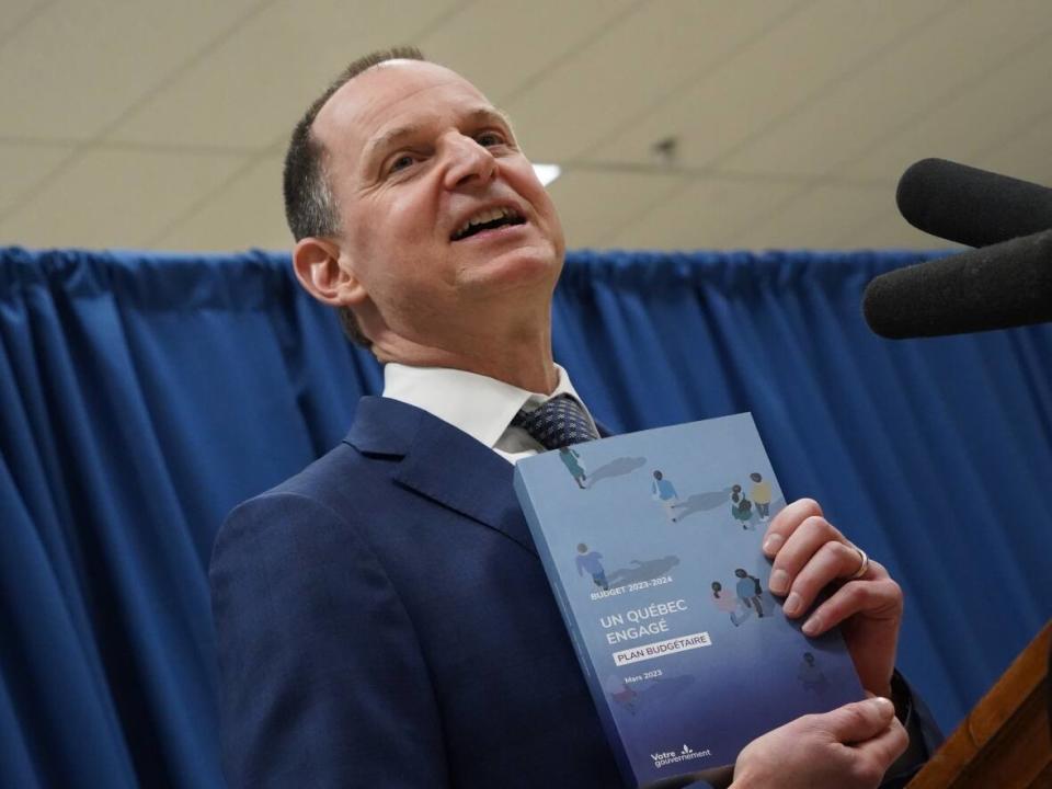 Quebec Finance Minister Eric Girard shows the cover of his budget on March 20, the eve of its official release. (Sylvain Roy-Roussel/Radio Canada - image credit)
