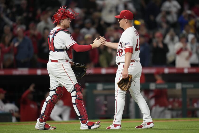 Los Angeles Angels catcher Chad Wallach (35) and relief pitcher Aaron Loup (28) celebrate after a 7-3 win over the Boston Red Sox in a baseball game in Anaheim, Calif., Wednesday, May 24, 2023. (AP Photo/ Ashley Landis)