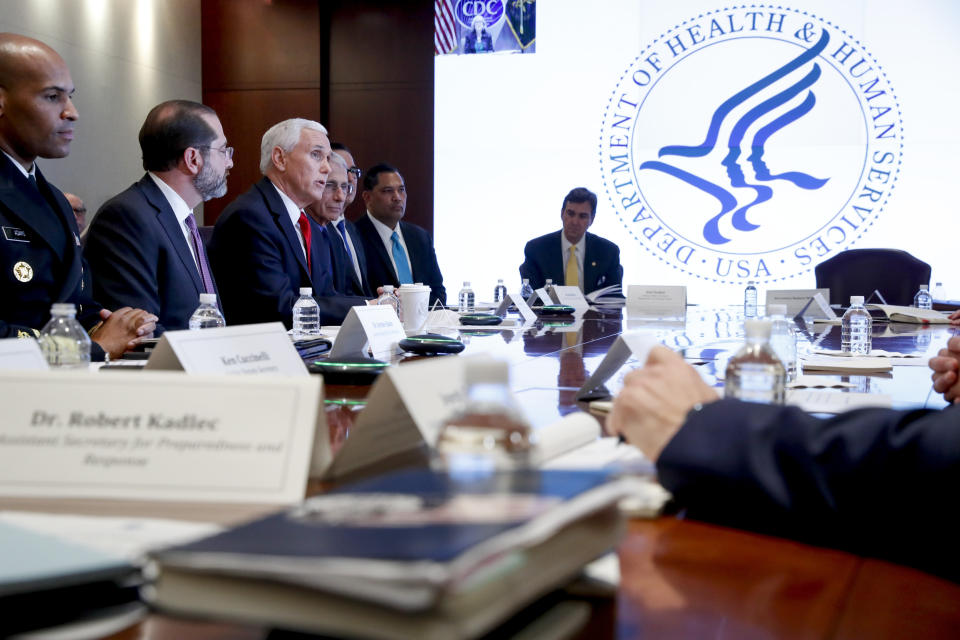 Vice President Mike Pence, third from left, accompanied by Surgeon General Jerome Adams, left, Health and Human Services Secretary Alex Azar, and others, speaks during a coronavirus task force meeting at the Department of Health and Human Services, Thursday, Feb. 27, 2020, in Washington. (AP Photo/Andrew Harnik)