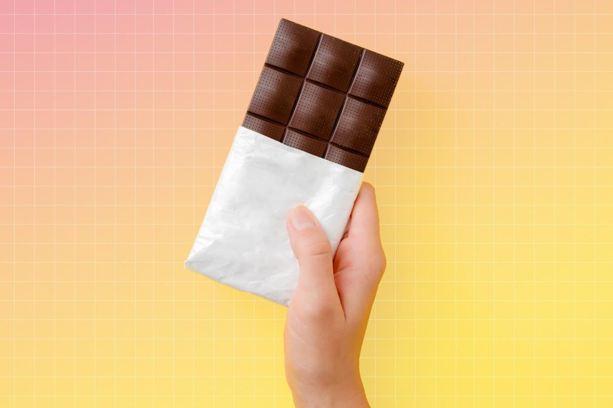 a photo of a hand holding up a chocolate bar