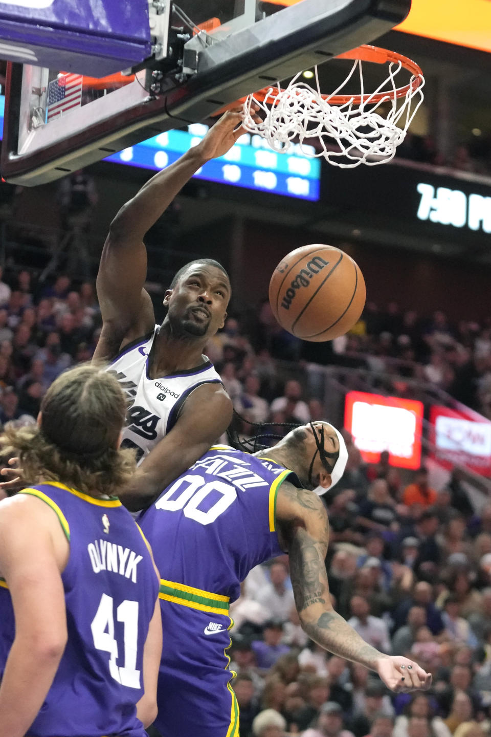 Sacramento Kings forward Harrison Barnes, left, dunks on Utah Jazz guard Jordan Clarkson (00) during the first half of an NBA basketball game Wednesday, Oct. 25, 2023, in Salt Lake City. (AP Photo/Rick Bowmer)