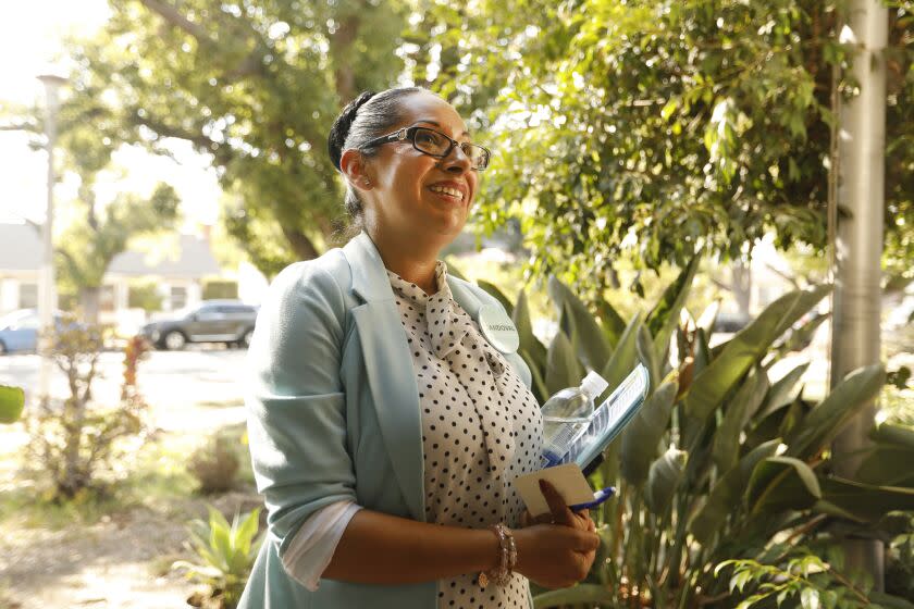 Wilmington, Los Angeles, California-Sept. 2, 2022-Danielle Sandoval, right, is running for a seat on the Los Angeles City Council in a district that stretches from San Pedro north to Watts. She goes canvassing in the historic district of Wilmington on Sept. 2, 2022. Sandoval is running to replace City Councilman Joe Buscaino, and wants more attention for Wilmington. (Carolyn Cole / Los Angeles Times)