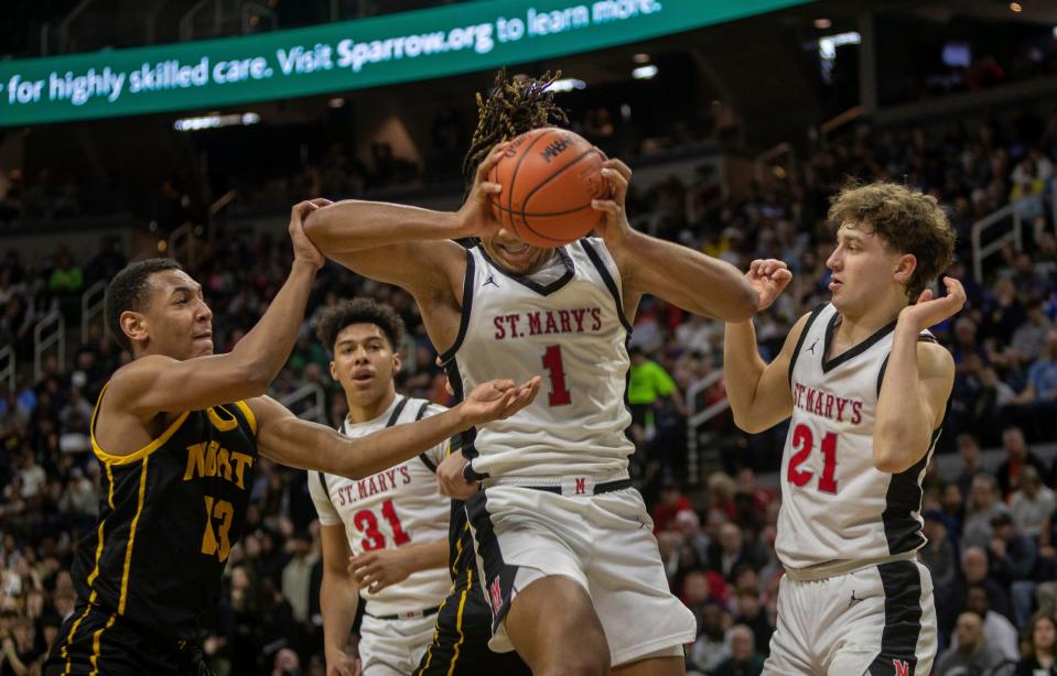 Orchard Lake St. Mary's Trey McKenney grabs a rebound during the MHSAA Div. 1 state finals against North Farmington inside the Breslin Center in East Lansing on Saturday, March 16, 2024.
