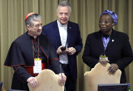 Sister Veronica Openibo, right, stands next to Chicago Archbishop Cardinal Blase J. Cupich, left, and Father Tomaz Mavric, center, as they wait for Pope Francis to arrive at the third day of a Vatican's conference on dealing with sex abuse by priests, at the Vatican, Saturday, Feb. 23, 2019. The prominent Nigerian nun has blasted the culture of silence in the Catholic Church that has long sought to hide clergy sexual abuse, telling a Vatican summit that transparency and an admission of mistakes is needed to restore trust. (AP Photo/Alessandra Tarantino, Pool)