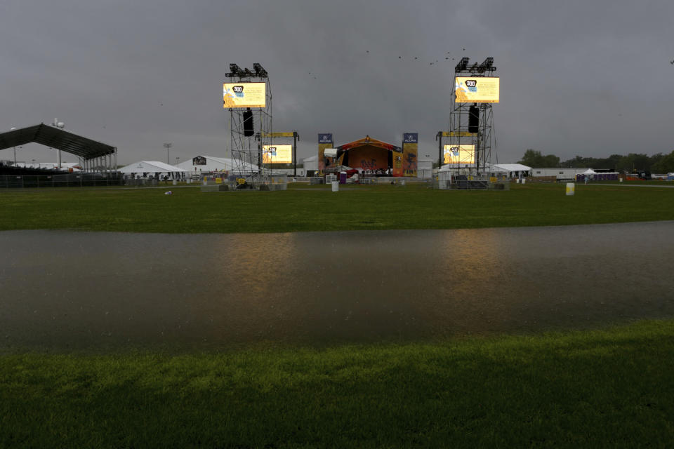 Storm clouds hover over the Acura stage at the New Orleans Jazz & Heritage Festival in New Orleans, Thursday, April 25, 2019. (AP Photo/Doug Parker}