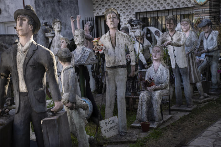 Human-scale figures depicting immigrants are displayed in the front garden of the family home of Italian Antonio Ierace, in Ciudadela, Argentina, Monday, Oct. 17, 2022. Ierace arrived in Buenos Aires from Italy in 1949, but decided to set up shop as a bricklayer in Ciudadela where he created the statues through the years in his workshop as a hobby. Ierace would display the statues, many portraying members of the working class, in his front yard because he knew that the people walking past appreciated them. (AP Photo/Rodrigo Abd)