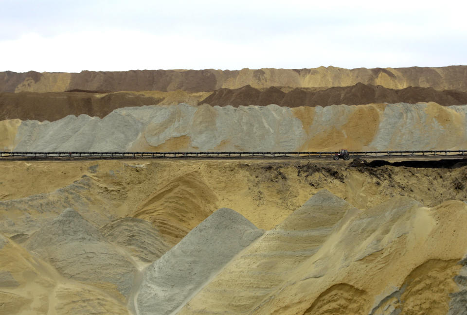 A man drives tractor at an open pit coal mine in Kostolac, 80 kilometers (50 miles) east of Belgrade, Serbia, Friday, April 11, 2014. A complete mammoth skeleton, named Vika discovered by Serbian archaeologists in 2009 inside the Kostolac open coal pit mine, was moved from the spot where it was found to a secure location because the pit mine threatened to endanger the safety of the remains. (AP Photo/Darko Vojinovic)