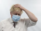 Britain's Prime Minister Boris Johnson gestures during a visit to Finchley Memorial Hospital, in North London, Tuesday, Jan. 18, 2022. (Ian Vogler, Pool Photo via AP)