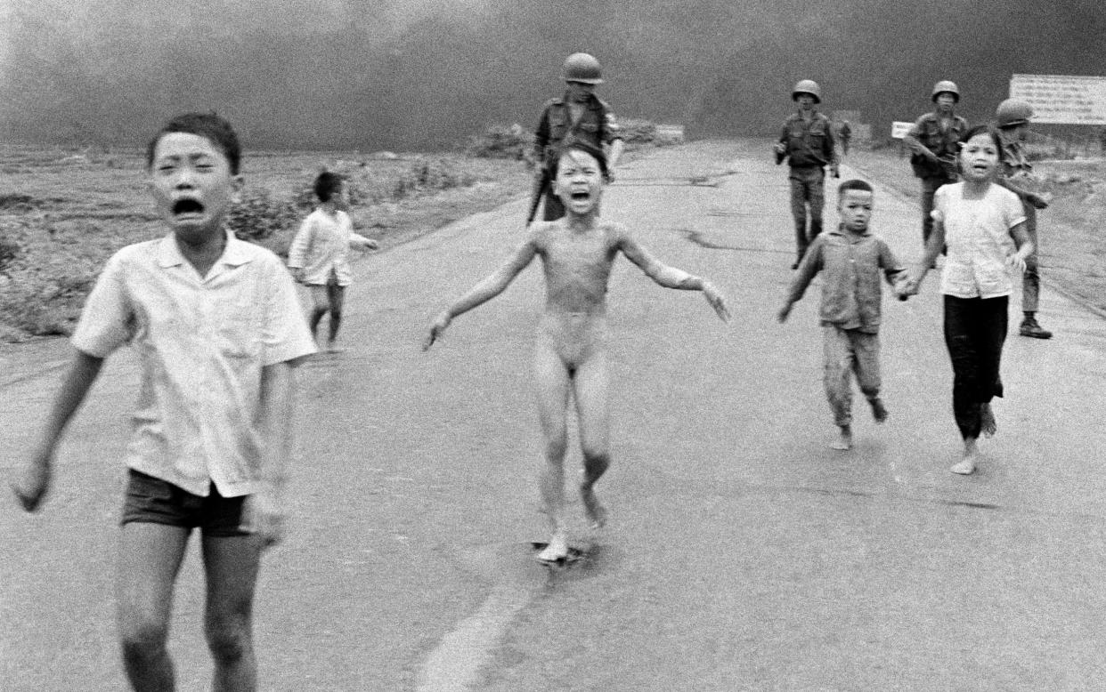 Kim Phuc photographed by Nick Ut in 1972, with her body covered in third degree burns after a napalm bomb hit her village in Vietnam - Nick Ut 