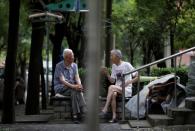 Elderly men chat at a residential community in downtown Beijing