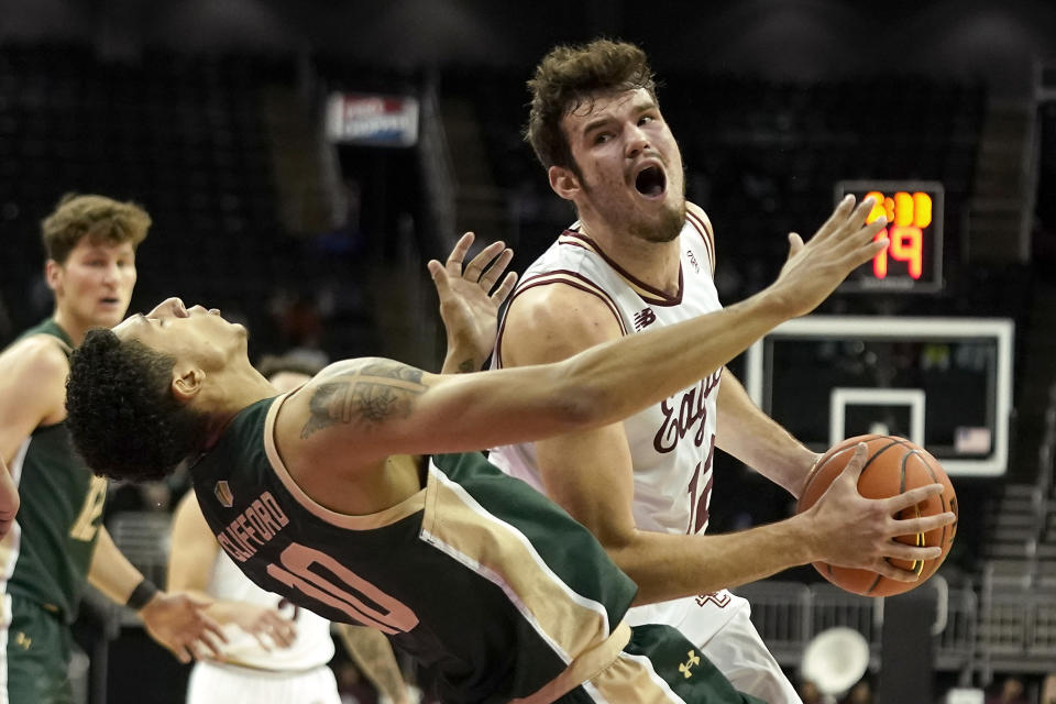 Boston College forward Quinten Post (12) looks to shoot under pressure from Colorado State guard Nique Clifford (10) during the first half of an NCAA college basketball game Wednesday, Nov. 22, 2023, in Kansas City, Mo. (AP Photo/Charlie Riedel)
