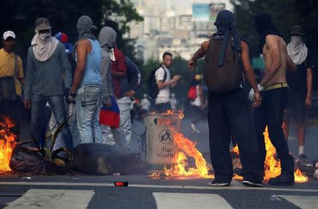 A fire barricade is seen on a street during an opposition rally in Caracas, Venezuela, April 8, 2017. REUTERS/Carlos Garcia Rawlins