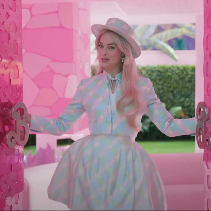 Margot wearing a bubble skirt, cropped blazer, and matching top hat