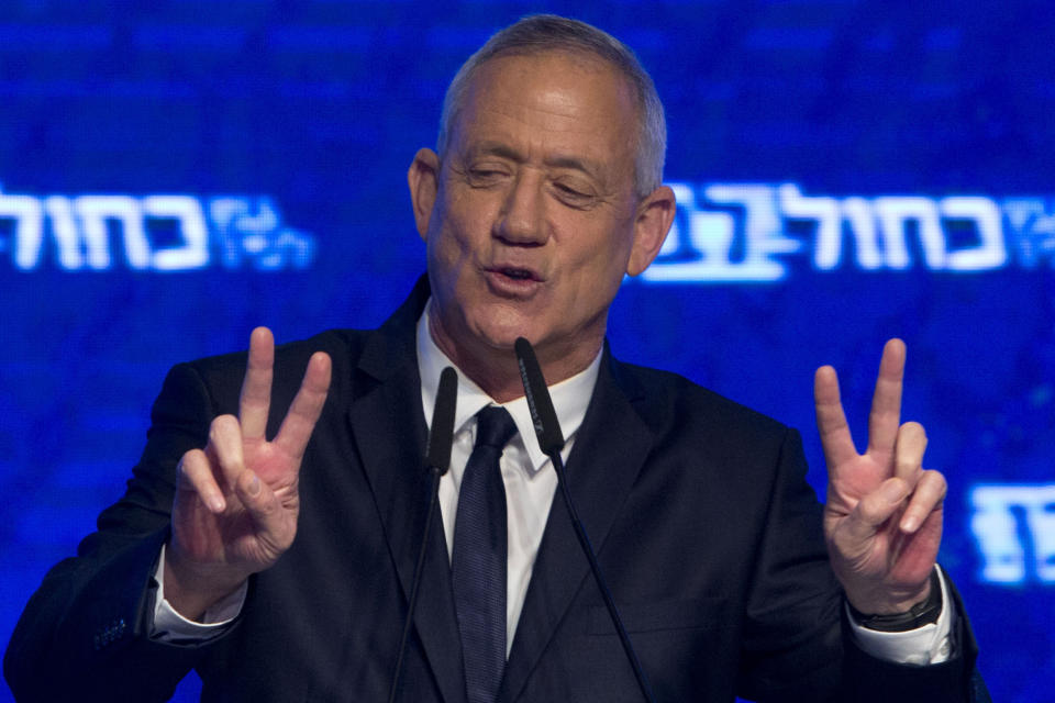 Blue and White party leader Benny Gantz flashes victory signs to his supporters after Israeli general elections polls closed, Wednesday, April 10, 2019 in Tel Aviv. (AP Photo/Sebastian Scheiner)