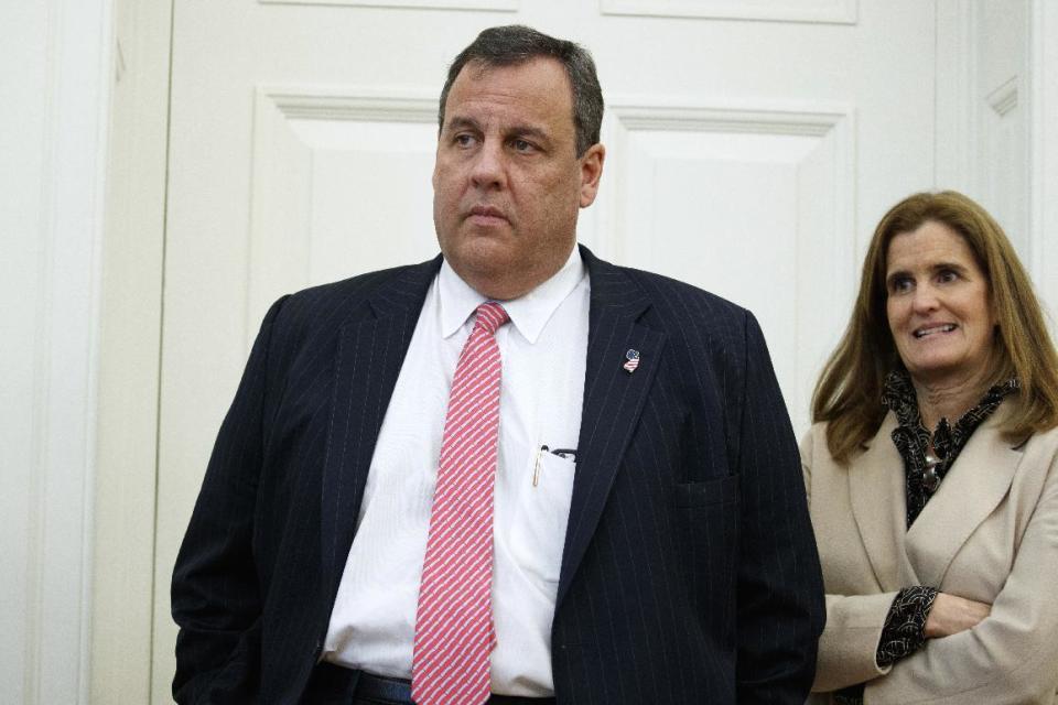 FILE- In this Tuesday, Feb. 14, 2017, file photo, New Jersey Gov. Chris Christie and his wife Mary Pat Christie watch as President Donald Trump signs House Joint Resolution 41 in the Oval Office of the White House in Washington. The state Chamber of Commerce’s 80th annual trip, nicknamed the “Walk to Washington” because rail riders generally pace the train’s corridors schmoozing and handing out business cards, on Thursday, Feb. 16, comes after a national election that hinged in part on repudiating insiders and establishment politics. Christie is set to deliver the keynote address to the gathering. (AP Photo/Evan Vucci, File)