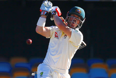 FILE PHOTO - Cricket - Ashes test match - Australia v England - GABBA Ground, Brisbane, Australia, November 26, 2017. Australia's David Warner reacts after missing a delivery from England's Chris Woakes during the fourth day of the first Ashes cricket test match. REUTERS/David Gray/File Photo