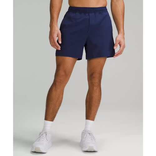 model wearing blue shorts with white socks and sneakers